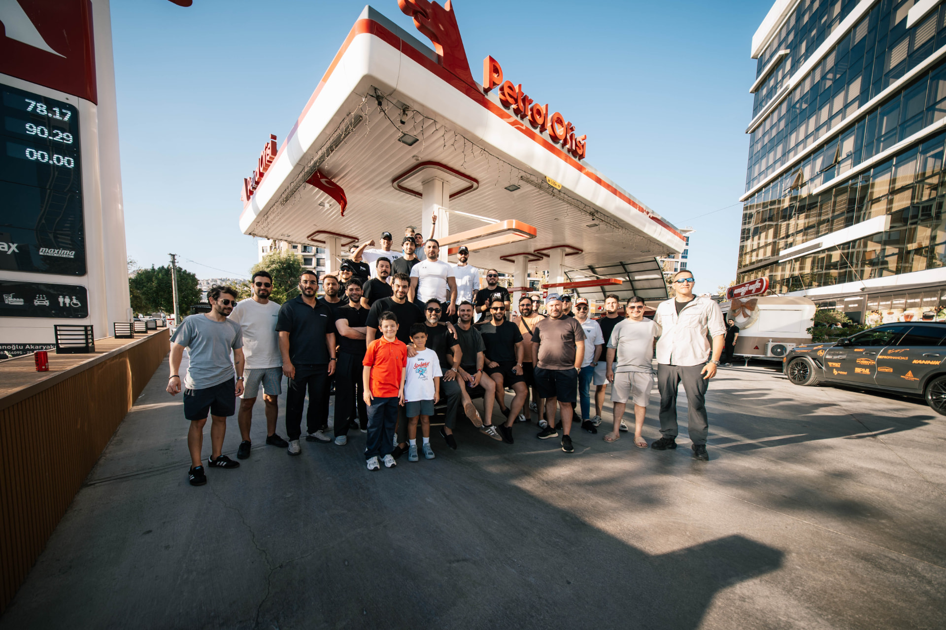 The group gathered for a photo at a fuel stop along the route