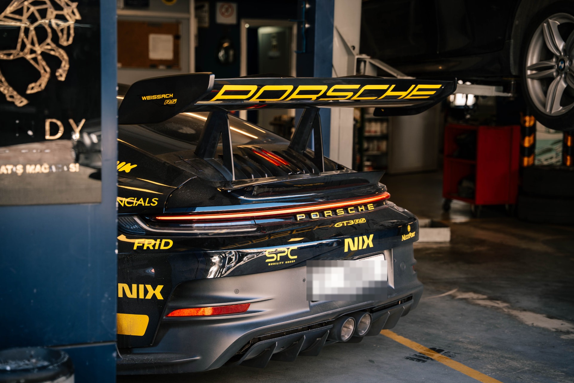 Performance car receiving attention in a garage